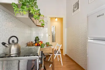 a kitchen with a stove and a table with a tea kettle at Aly Apartment in Vatican in Rome