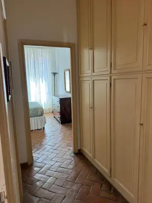 a room with a bedroom with a bed and a mirror at Borgo in Elegante appartamento in Rome