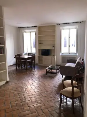 a kitchen with blue and white checkered walls and shelves at Borgo in Elegante appartamento in Rome