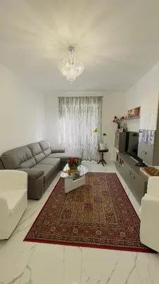 a living room with a couch and a rug at Marconi House - A un passo da Trastevere in Rome