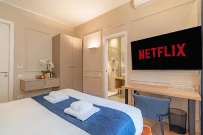 a hotel room with a bed and a tv on the wall at Cipro Vatican Luxury Escape in Rome