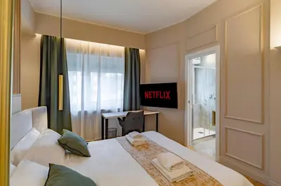 a hotel room with a bed and a desk at Cipro Vatican Luxury Escape in Rome