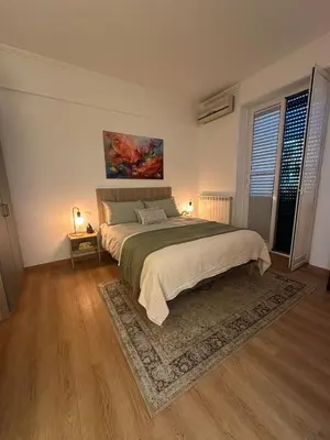 a bedroom with a large bed and a rug at 'Boh House' in Rome
