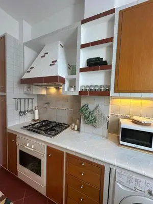 a kitchen with a stove and a stove top oven at 'Boh House' in Rome