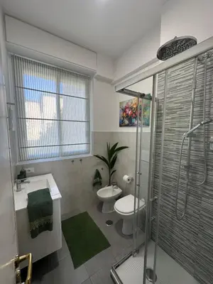a bathroom with a toilet and a sink and a shower at 'Boh House' in Rome