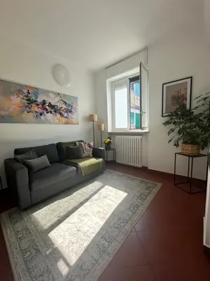 a living room with a couch and a window at 'Boh House' in Rome
