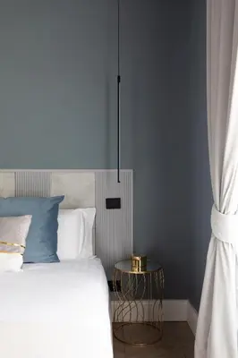 a bedroom with a bed and a side table at Navona - Luxury, design and Jacuzzi style in Rome