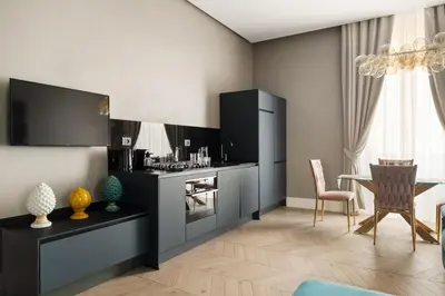 a kitchen with a table and a dining room at Navona - Luxury, design and Jacuzzi style in Rome