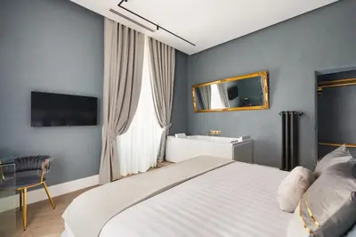 a bedroom with a large bed and a mirror at Navona - Luxury, design and Jacuzzi style in Rome