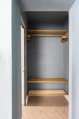 an empty room with wooden shelves and a blue wall at Navona - Luxury, design and Jacuzzi style in Rome