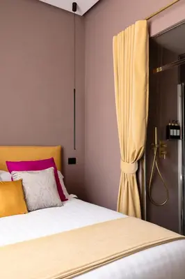 a bedroom with a bed and a curtain at Navona - Luxury, design and Jacuzzi style in Rome