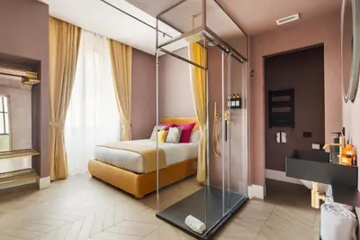 a hotel room with a bed with a glass canopy at Navona - Luxury, design and Jacuzzi style in Rome