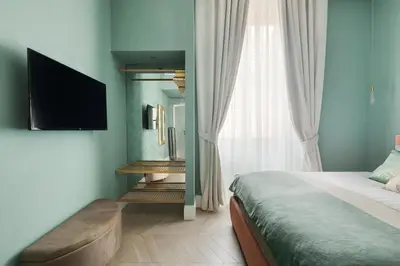 a bedroom with a bed and a flat screen tv at Navona - Luxury, design and Jacuzzi style in Rome