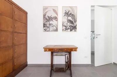 a desk in a room with two pictures on the wall at Gilda's Home in Rome