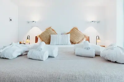 a white bedroom with two beds with white pillows at Skylife 360 Rooftop Penthouse in Rome
