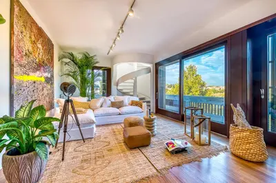 a living room with a white couch and large windows at Skylife 360 Rooftop Penthouse in Rome
