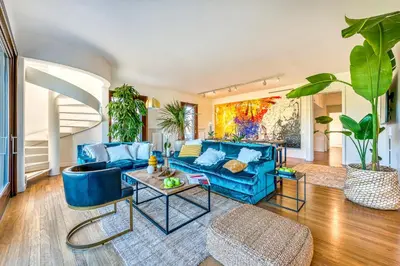 a living room with a blue couch and a table at Skylife 360 Rooftop Penthouse in Rome