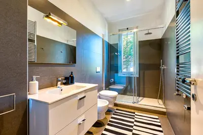 a bathroom with a sink and a toilet and a shower at Skylife 360 Rooftop Penthouse in Rome
