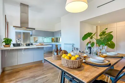 a kitchen and dining room with a table with fruit on it at Skylife 360 Rooftop Penthouse in Rome