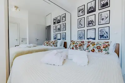 two beds in a room with pictures on the wall at Skylife 360 Rooftop Penthouse in Rome