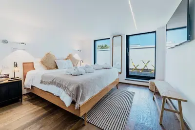 a bedroom with a large bed and large windows at Skylife 360 Rooftop Penthouse in Rome