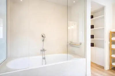 a bathroom with a tub and a glass shower at Elegantis Monti Royal Apartment with private terrace in Rome