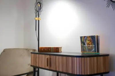a table with a lamp next to a chair at Elegantis Monti Royal Apartment with private terrace in Rome