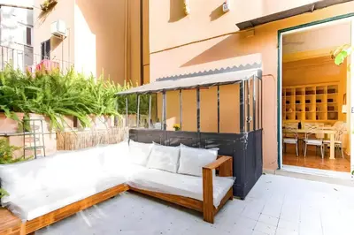 a patio with a couch and a table at Elegantis Monti Royal Apartment with private terrace in Rome