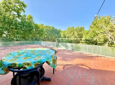 a table and a chair on a patio at Bauhouse in Rome