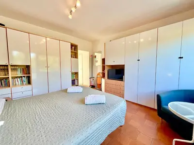 a bedroom with a large bed and a blue couch at Bauhouse in Rome