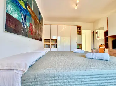 a bedroom with a large bed with a painting on the wall at Bauhouse in Rome