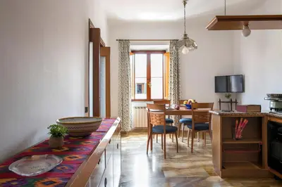 a kitchen and dining room with a table and chairs at Paramount Penthouse in Rome