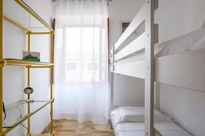 a bedroom with two bunk beds and a window at Paramount Penthouse in Rome