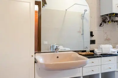 a bathroom with a sink and a mirror at Paramount Penthouse in Rome