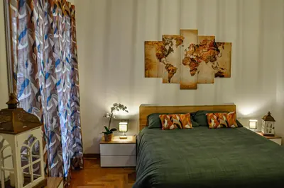a bedroom with a bed with four paintings on the wall at Moletta 17 in Rome