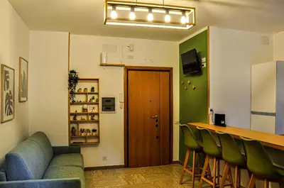 a bar in a restaurant with green chairs and a counter at Moletta 17 in Rome