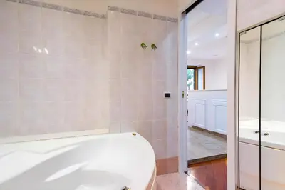 a bathroom with a white tub and a toilet at Elegantis San Giovanni Suite - Chic Apartment with Bathtub Near Historic Center, Metro & Tram Nearby in Rome