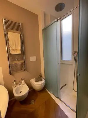 a bathroom with a glass shower and a toilet at Ciambix Home Roma Vatican in Rome