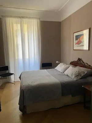 a bedroom with a large bed and a window at Ciambix Home Roma Vatican in Rome