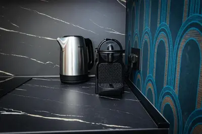 a coffee pot sitting on a counter next to a wall at Puro Suite Frezza in Rome