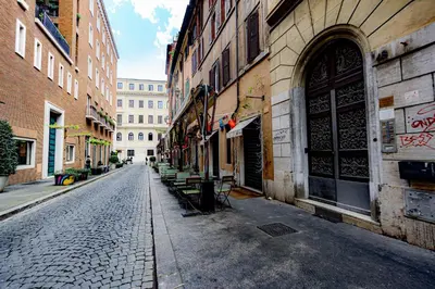 a cobblestone street in a city with buildings at Puro Suite Frezza in Rome