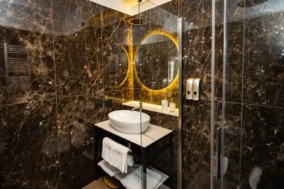 a bathroom with a sink and a mirror at Puro Suite Frezza in Rome