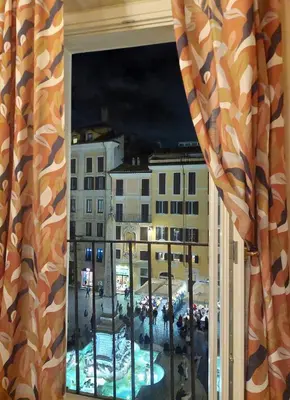a window with a view of a city at night at Pantheon in finestra in Rome