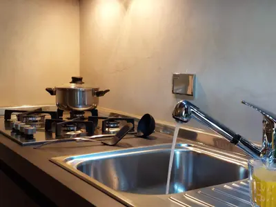 a kitchen sink with a pot on a stove at Pantheon in finestra in Rome