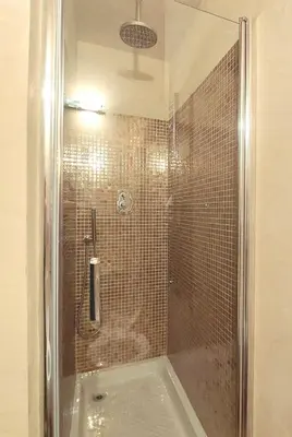 a shower with a glass door in a bathroom at Pantheon in finestra in Rome