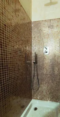 a tiled bathroom with a shower and a tub at Pantheon in finestra in Rome