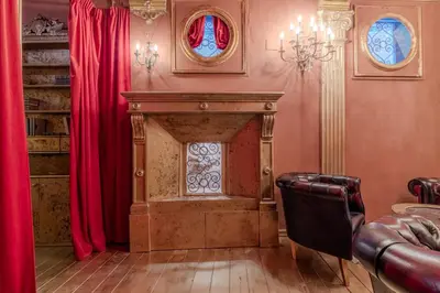 a living room with a fireplace and red curtains at Villino Ermes Campanelli in Rome