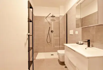 a bathroom with a shower and a toilet and a sink at La Casa di Chantal in Rome