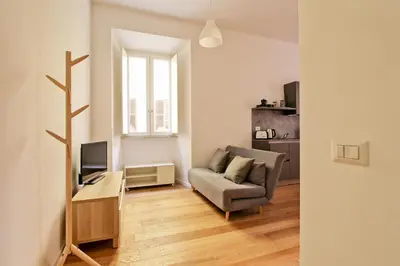 a living room with a couch and a television at La Casa di Chantal in Rome