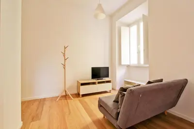 a living room with a couch and a television at La Casa di Chantal in Rome